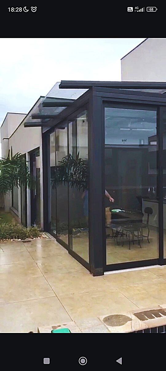 Cobertura de vidro em estrutura de alumínio fechando uma sacada