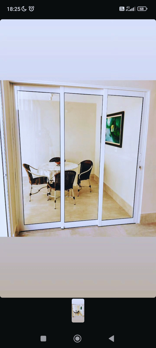 Porta de vidro de alumínio dando acesso à sala de jantar